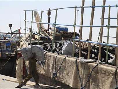 Workers load goods onto ships at the port in Deira February 27, 2012. Foto: Ashraf Abu Omar / Reuters In English