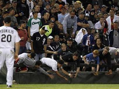 Fans reach for a foul ball during the MLB American League baseball game between Chicago White Sox and New York Yankees, in Chicago, August 20, 2012. Foto: Jeff Haynes / Reuters In English