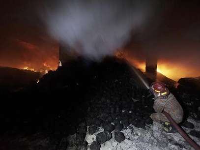 A worker calls for help as he is trapped in an 11-storey garment factory building where a fire had broken out, in the suburb of Uttara in Dhaka November 26, 2012. Foto: Stringer / Reuters