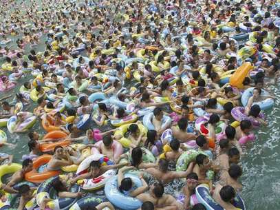Residents crowd in a swimming pool to escape the summer heat during a hot weather spell in Daying county of Suining, Sichuan province in this July 4, 2010 file picture. China is mulling changes to its one-child policy, a former family planning official said, with government advisory bodies drafting proposals in the face of a rapidly ageing society in the world's most populous nation. Proposed changes would allow for urban couples to have a second child, even if one of the parents is themselves not an only child, the China Daily cited Zhang Weiqing, the former head of the National Population and Family Planning Commission, as saying on November 28, 2012. Foto: Stringer / Reuters