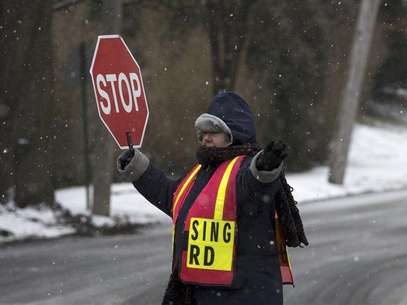 Un guardia de cruce en una intersección de calles tras el cierre de escuelas a consecuencia del clima en Pelham, EEUU, feb 8 2013. Una ventisca empezó a azotar el viernes el noreste de Estados Unidos, reduciendo la semana laboral para millones de personas que temían quedarse atrapadas en las carreteras, dado que las autoridades ordenaron el cierre de las vías antes de la nevazón que según meteorólogos podría superar récords. Foto: Adrees Latif / Reuters