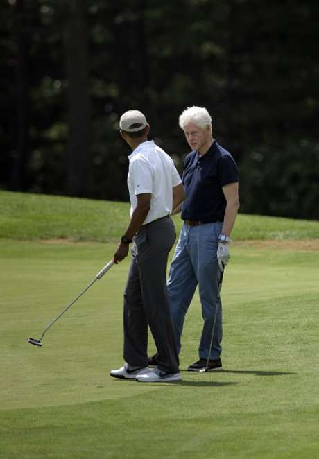Brendan Smialowski / Getty Images Obama e Clinton jogam golfe nos EUA