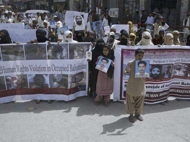 Women and children hold images of their missing relatives during a demonstration in Quetta September 15, 2012. For years, human rights groups had hoped that Western governments might lead an international outcry over a little-known epidemic of abductions, torture and murder in the Pakistani province of Baluchistan. They were disappointed. Instead, relatives of the missing are placing their faith in a visiting U.N. team to highlight allegations that security forces are waging a campaign of mass disappearanc Foto: Naseer Ahmed / Reuters