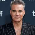 Robbie Williams fala sobre rumores de "substância branca" ter caído de sua boca durante entrevista