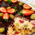 Bombom aberto na travessa combinando morango e uva com um creme divino e cobertura de chocolate