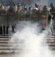 Oficiais da Guarda Nacional avançam contra manifestantes antio-governo durante confrontos na praça Altamira, em Caracas, neste domingo, 16 de março  Foto: Reuters