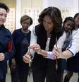 Peng Liyuan tenta ensinar Michelle Obama a reproduzir um caractere chinês  Foto: AP
