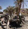 Pessoas se reúnem perto de um carro destruído por um ataque aéreo de um drone dos EUA; alvos foram militantes da Al-Qaeda em agosto de 2012  Foto: Reuters