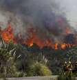 Bombeiros observam de perto as chamas, enquanto se preparam para proteger uma casa, em San Marcos, na região de San Diego, na Califórnia, Estados Unidos, nesta quinta-feira. 15/05/2014  Foto: Mike Blake / Reuters