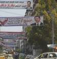 <p>Faixas com o rosto do atual presidente sírio, Bashar al-Assad, foram colocadas em ruas da cidade de Latika, em 24 de maio. As eleições presidenciais acontecem no dia 3 de junho</p>  Foto: AP
