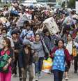 <p>Cambojanos carregam seus pertences enquanto caminham para atravessar a fronteira em Aranyaprathet, em Sa Kaew, Tail&acirc;ndia, em 15 de junho</p>  Foto: Reuters