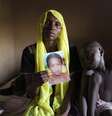 <p>Uma mulher mostra a foto da filha, sequestrada em maio de 2014 pelo Boko Haram em Maiduguri</p>  Foto: Joe Penney / Reuters