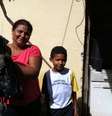 <p>Luzineide carrega o "xodó" Neguinho ao lado de um de seus filhos</p>  Foto: Elisa Feres / Terra
