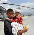 Homem segura uma criança, ferida no terremoto de sábado, depois que soldados indianos os levaram de Trishuli Bazar ao aeroporto em Katmandu, no Nepal, nesta segunda-feira  Foto: Jitendra Prakash / Reuters
