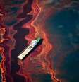 Um barco à deriva em meio ao vazamento de petróleo provocado pelo acidente da plataforma petrolífera Deepwater Horizon, no Golfo do México, em abril de 2010.   Foto: Causa e Efeito/Daniel Beltrá / BBC News Brasil