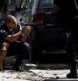 Policial se posiciona durante operação contra traficantes na Cidade de Deus, no Rio de Janeiro  Foto: Reuters