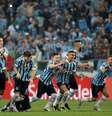 Gremistas correm para comemorar classificação nas oitavas de final diante do Estudiantes  Foto: Diego Vara / Reuters