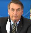 Em coletiva de imprensa nesta quarta-feira, 18, presidente tirou a máscara para falar ao microfone  Foto: TV Brasil / Reprodução / Estadão Conteúdo