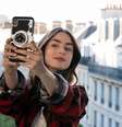 Emily (Lily Collins) leva um choque de realidade em Paris: o excessivo otimismo americano se depara com o pragmatismo às vezes cruel dos franceses   Foto: Divulgação