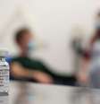 A test volunteer and medical worker behind a vial of the Oxford-AstraZeneca vaccine  Foto: John Cairns/University of Oxford HO / BBC News Brasil