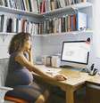 Grávida trabalhando diante do computador; 'é um tabu gigante' no mercado de trabalho, escreveu uma mulher que foi contratada durante a gestação  Foto: Getty Images / BBC News Brasil