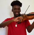 Carlos Samuel, de 20 anos, foi salvo por violino durante tiroteio no Rio de Janeiro  Foto: Arquivo pessoal / BBC News Brasil