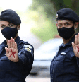 A foto mostra duas policiais com um x vermelho na mão, símbolo contra a violência doméstica  Foto: Imagem: Divulgação/Aluno Sargento Picanço e Soldado Jordan / Alma Preta