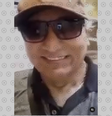 Homem de boné e óculos escuros sorri. Legenda o identifica como Gilberto Tomazoni, ‘dono da JBS’  Foto: Aos Fatos