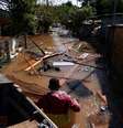Na foto, Valderci Trindade, 24, que perdeu a própria casa, tenta salvar itens úteis na enchente em Serraria, Porto Alegre, Rio Grande do Sul. (14/05/2024)  Foto: REUTERS/Diego Vara