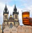 Homem segura copo de cerveja ao longo da cidade de Praga  Foto: BreakingTheWalls/GettyImages