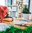 mulher com chapeu de papai noel descansa a cabeça em mesa de escritório  Foto: Getty Images / BBC News Brasil