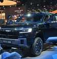 Modelo da chinesa Fangchengbao em exposição na Feira Internacional de Carros de Xangai, em 23/4/25.  Foto: AFP - HECTOR RETAMAL / RFI