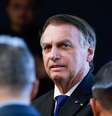Ex-presidente Jair Bolsonaro com broches pendurados em seu paletó  Foto: Fellipe Sampaio/STF / Flickr