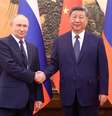 Presidentes da Rússia, Vladimir Putin, e da China, Xi Jinping, cumprimentam-se em Pequim  Foto: China Daily  / Reuters