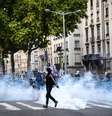 Manifestante caminha entre nuvem de fumaça durante protesto em Lyon, nesta quarta-feira, 10 de setembro de 2025.  Foto: AFP - OLIVIER CHASSIGNOLE / RFI