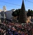 Cenenas de fiéis se reúnem ao lado da árvore de Natal na Praça da Manjedoura, na véspera de Natal, na Cidade Velha de Belém, na Cisjordânia ocupada por Israel, em 24 de dezembro de 2025.  Foto: REUTERS - Mussa Qawasma / RFI