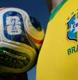 Pessoa com a camisa oficial da seleção brasileira segurando a bola oficial da Copa do Mundo de 2026  Foto: Getty Images / BBC News Brasil
