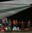 Membros da Força Aérea da Bolívia e equipes de resgate carregam ajuda humanitária em uma aeronave C-130 Hércules, que será enviada para operações de busca e resgate após os terremotos na Venezuela. Base Aérea “Diablos Negros”, em El Alto, Bolívia, em 29 de junho de 2026.  Foto: REUTERS - Claudia Morales / RFI
