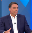 Flávio Bolsonaro vai à sabatina com mensagem escrita na mão  Foto: Reprodução/Globo