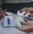 Zoom em um eleitor reconhecendo a digital para votar; em primeiro plano, mão de mesária segura título de eleitor  Foto: Joédson Alves/Agência Brasil / BBC News Brasil