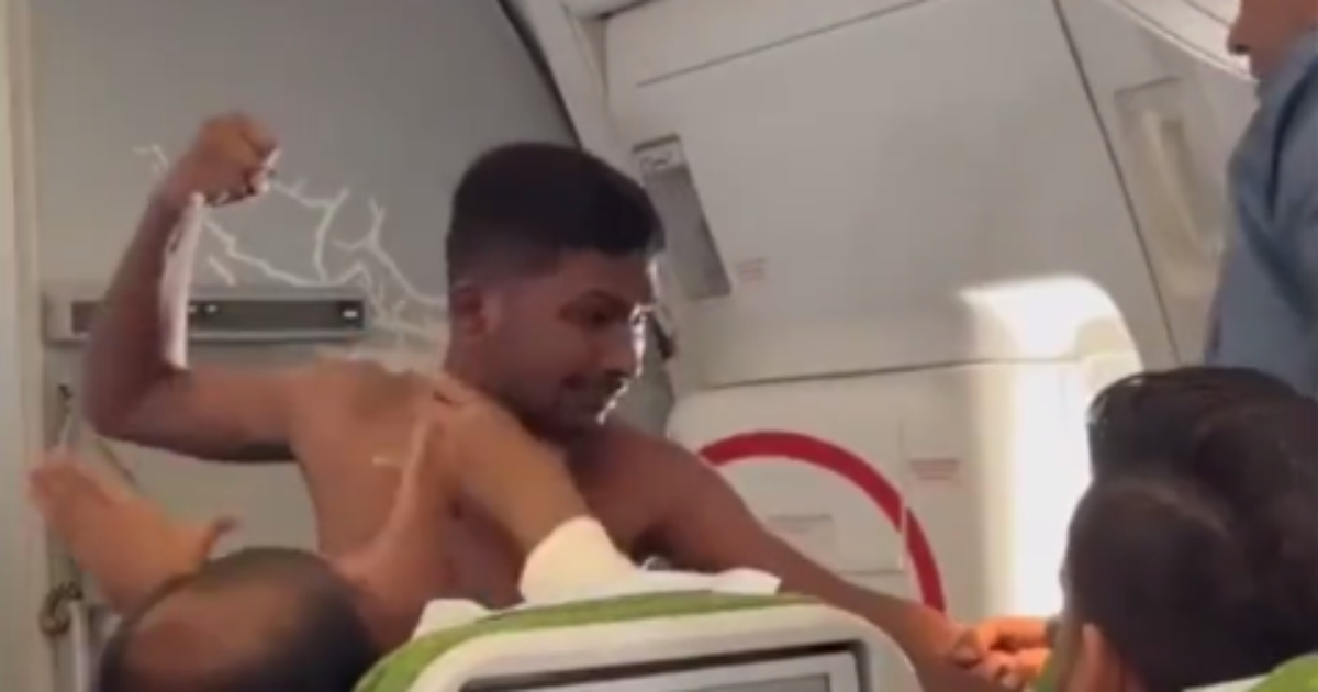 shirtless exchanging punches with another man inside the plane;  Watch the video