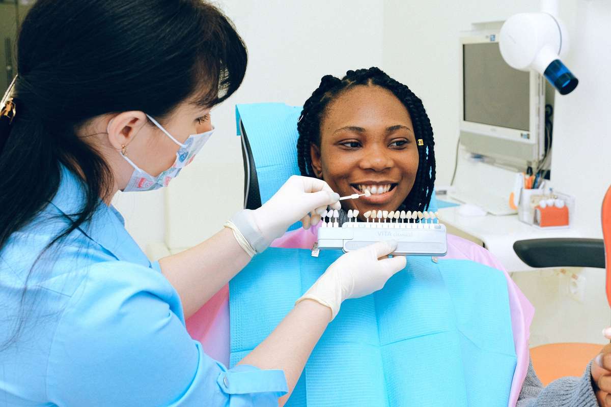 Dentist assessing a patient's tooth shade before Zoom whitening
