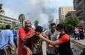 14 de agosto - Simpatizantes de Mursi fogem de gás lacrimogêneo disparado pela polícia durante ofensiva no Cairo