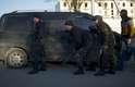 22 de março - Soldados pró-russos escondem atrás de carro na base militar aérea de Sebastopol