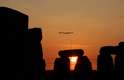 Sol é visto através de pedras de um monumento histórico, na Inglaterra