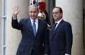 O primeiro-ministro israelense, Benjamin Netanyahu, acena para os jornalistas ao ser recebido por Hollande no Palácio do Eliseu