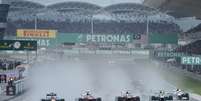 Pilotos iniciaram corrida com pneus intermediários devido à chuva que caiu em Sepang antes da largada  Foto: AFP