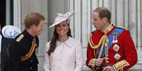 Kate, que espera um filho para julho, exibe a barriga durante conversa com o marido, o príncipe William (dir.), e o cunhado Harry   Foto: AP