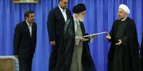 Aiatol&aacute; Ali Khamenei (C) entrega a carta de refer&ecirc;ncia ao novo presidente Hassan Rohani (D)  Foto: EFE