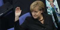 Merkel durante a votação que lhe garantiu o terceiro mandato  Foto: AFP